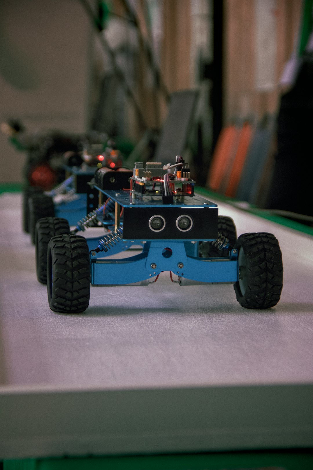 several-blue-robotic-vehicles-with-wheels-lined-up-2r05wcbe4a